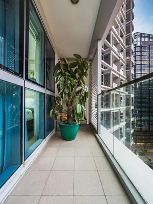 a balcony with a potted plant on a building at Uptown Parksuites Balcony Mall View in Manila