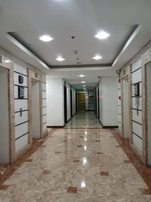 an empty hallway of a building with doors and ceilings at Manila bay view condo birch tower in Manila