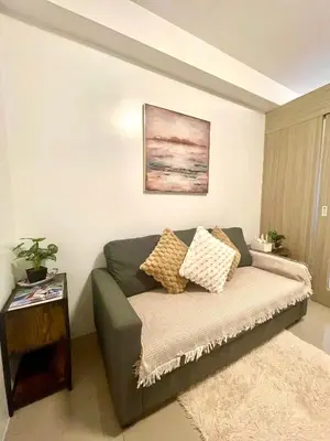 a living room with a couch and a table at Shore Residences Tower B in Manila