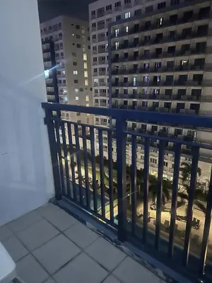 a balcony with a view of a city at night at Sea Residences Tower A 9th floor pool view in Manila