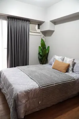 a large bed in a bedroom with a window at Exquisite Property Stays at Acacia Estate Taguig City in Manila