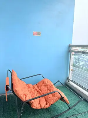 an orange bed in a room with a window at 1 bedroom at Azure Urban Resort Condo in Manila