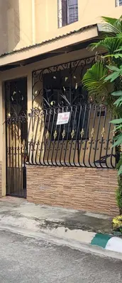 a wrought iron gate in front of a building at Cozy Bian Getaway - Entire House for Rent in Biñan