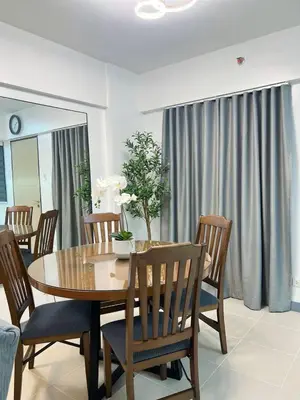 a dining room with a wooden table and chairs at Raya and Zane in Manila