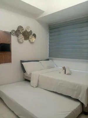 a bedroom with two beds and a window at Cozy Condo Near US Embassy in Manila in Manila