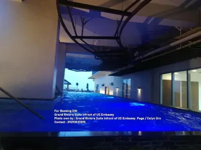 a swimming pool with blue lighting in a building at Cozy Condo Near US Embassy in Manila in Manila