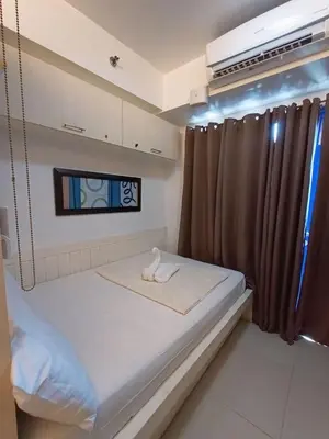 a small bed in a room with a window at Sea Residences Near MOA SMX Pasay City in Manila