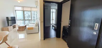 a room with a black door and a living room at Condotels by Irene in Manila