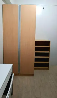 a room with a closet and a wooden door at Cozy Modern 2 Bedroom 81 Newport Boulevard in Manila