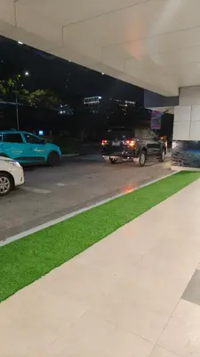 a group of cars parked in a parking lot at night at Josh place Shell residence MOA in Manila