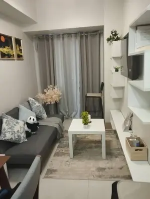 a living room with a couch and a table at Wowstaycation in Manila