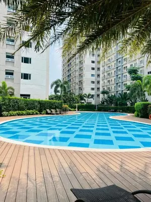 a large blue swimming pool in front of a building at Haute Haven - 1br with Balcony in Manila
