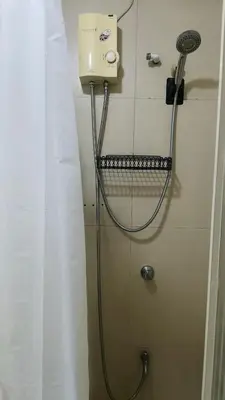 a shower with a hose hooked up to a wall at 2 Bedroom MEZZA RESIDENCES in Manila