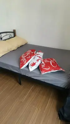 two red and white pillows sitting on a bed at 2 Bedroom MEZZA RESIDENCES in Manila
