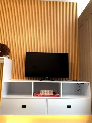 a flat screen tv on a white entertainment center at Direct Pool Access in Shore Residences near SM MOA in Manila