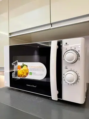 a microwave with a picture of food in it at Canal View Luxury Stay, Studio type , Massage Chair, Office Desk in Manila