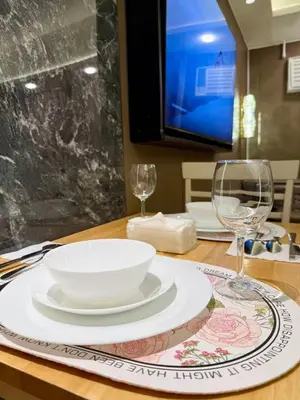 a table with a bowl and two wine glasses on it at Canal View Luxury Stay, Studio type , Massage Chair, Office Desk in Manila