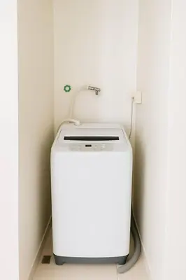 a white washing machine sitting in a room at SMDC BREEZE Manila Bay Sunset View in Manila