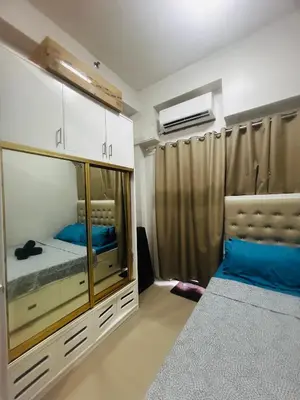 a bedroom with a bed and a large mirror at Cozy Staycation at Shore Residences near Mall Of Asia MOA in Manila