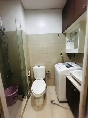 a small bathroom with a toilet and a sink at Cozy Staycation at Shore Residences near Mall Of Asia MOA in Manila