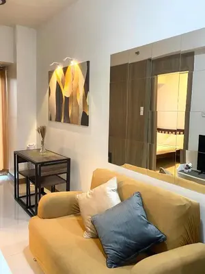 a living room with a couch and a table at 1BR Cozy Minimalist Unit near MOA or Manila Bay in Manila