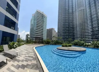 a large swimming pool in a city with tall buildings at Sunbeam - Air Residence 42nd floor in Manila