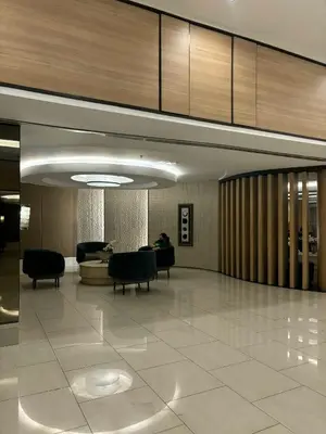 a lobby with couches and chairs in a building at Shell Residences Tower A B in Manila