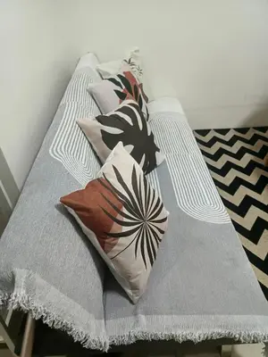 a bed with pillows on it in a room at Shore residences Yen and Yan Staycation in Manila