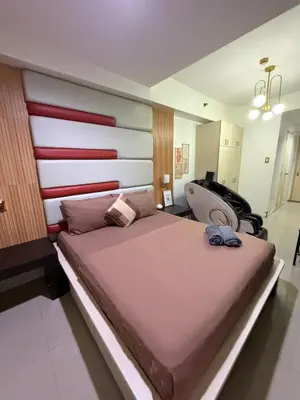 a bedroom with a large bed and a bath tub at Staycation By ABY Tower E Sea Residences in Manila