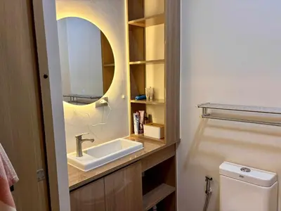 a bathroom with a sink and a mirror at GRACE RESIDENCES Condo in Manila