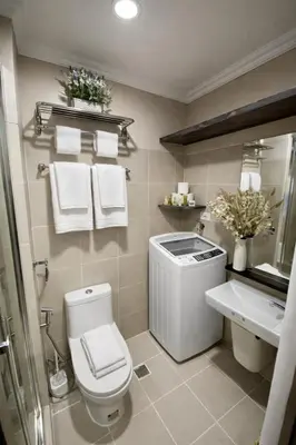 a bathroom with a toilet and a sink and towels at 2 BR Fully Furnished Condo in Parañaque with Pool and Parking - Bloom Unit 1133 in Manila
