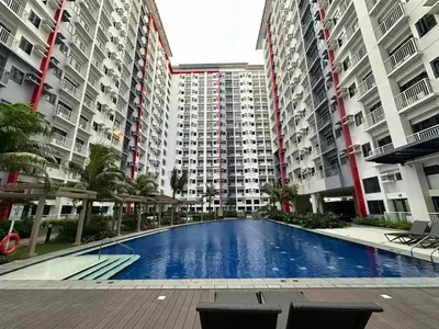 a large swimming pool in the middle of two buildings at 2 BR Fully Furnished Condo in Parañaque with Pool and Parking - Bloom Unit 1133 in Manila