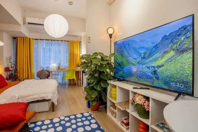 a living room with a large flat screen tv at Modern Studio with Balcony near Ayala Makati in Manila