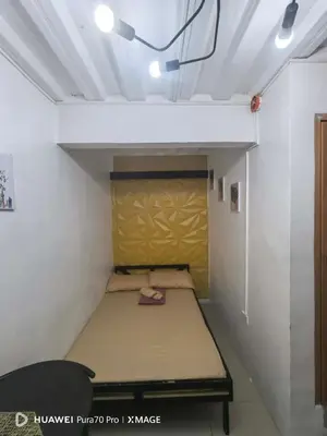 a small bed in a small room with a ceiling at Transient Room for Bypackers in Imus NO CAR PARK in Imus