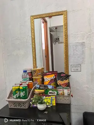 a table with a pile of food and a mirror at Transient Room for Bypackers in Imus NO CAR PARK in Imus