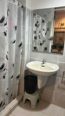 a bathroom with a sink and a shower curtain at smdc condotel in Manila