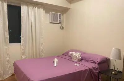 a room with a purple bed with a cross on it at 2 Bedroom Premium Condominium Beacon Makati in Manila
