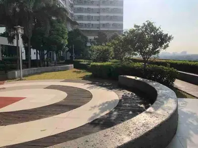 a walkway in a park with a building in the background at Japandi Suite City Skyline View Condo Makati in Manila