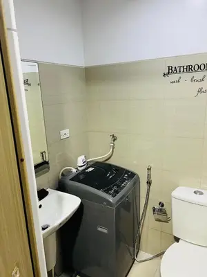 a small bathroom with a sink and a toilet at ESY Condotel shore 1-B in Manila