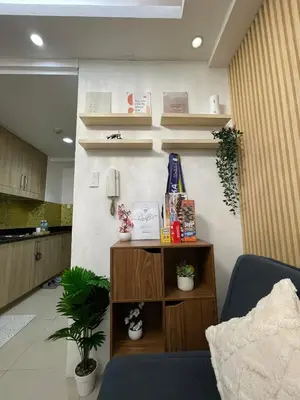 a room with a table with a trophy on the wall at AC Haven in Shore Residences near MOA Pasay City in Manila