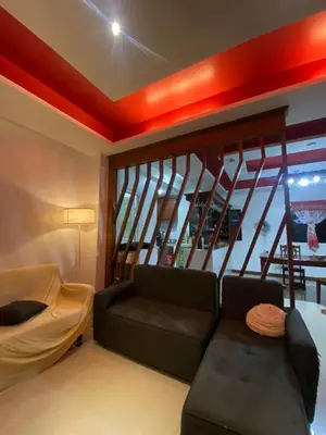 a living room with a couch and a large window at Upzora in Manila