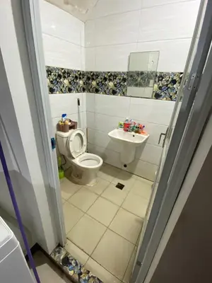 a bathroom with a toilet and a sink at Upzora in Manila