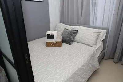 a bedroom with a bed with two boxes on it at The Place To Be with Balcony and Kitchen Mandaluyong in Manila