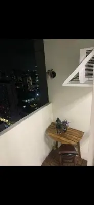 a small wooden table in a room with a window at Essel s Comfy Place in Manila