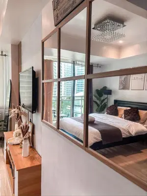 a bedroom with a large mirror on the wall at Casa Del Sol in Manila