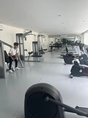 a gym with a man sitting on a treadmill at Veranda Arca South in Manila
