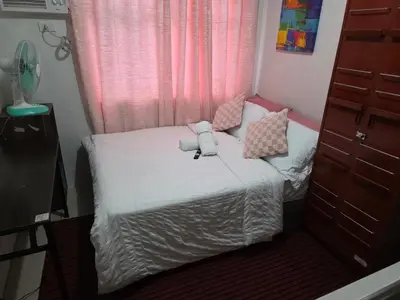 a small bed in a small room with a window at nicecondotel in Manila