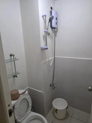 a small bathroom with a toilet and a shower at nicecondotel in Manila