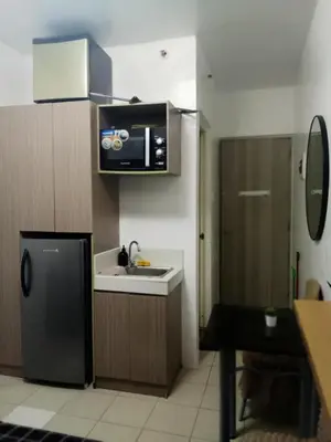 a small kitchen with a sink and a refrigerator at Staycation Condotel Urban Deca Tower Edsa Mandaluyong in Manila