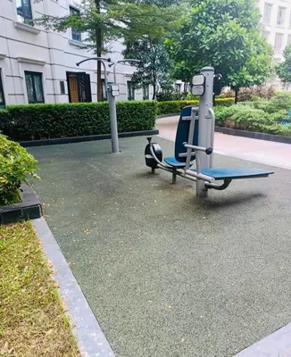 a gym with a bench in a park at Klassi Executive Stay near NAIA in Manila